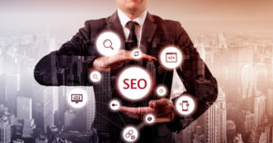 Businessman suggested effective 'SEO' optimisation approach. Hands presenting a 'SEO' flowchart.